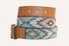 A Drewski belt from Zilker Belts, crafted using world-class Argentine leather and featuring an artisan Argentine fabric section adorned with vibrant geometric designs, elegantly coiled with a metal buckle.