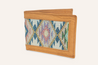 The Drewski Wallet by Zilker Belts is a handcrafted leather wallet featuring vibrant Argentine woven fabric with diamond shapes in multiple colors on the front.